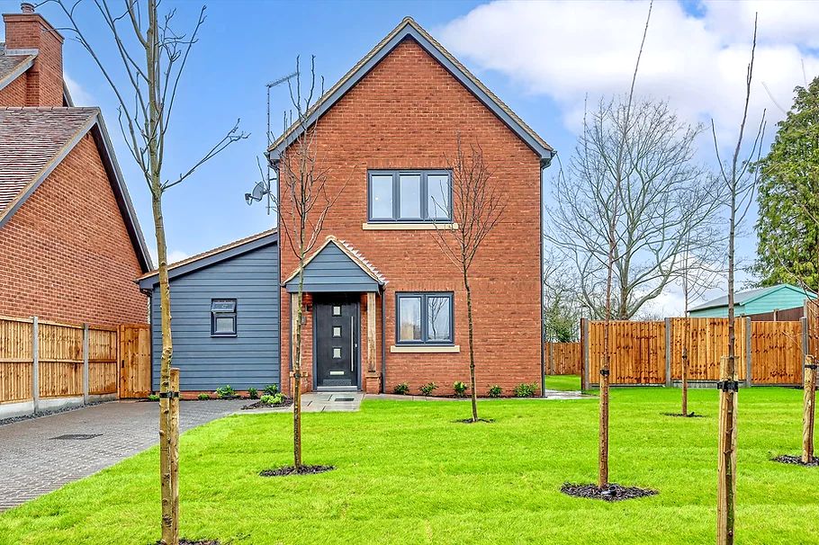 New-build style house with pitched roof and cladding